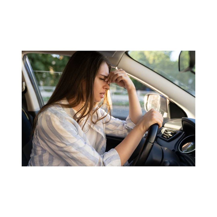 Women tired at wheel of car