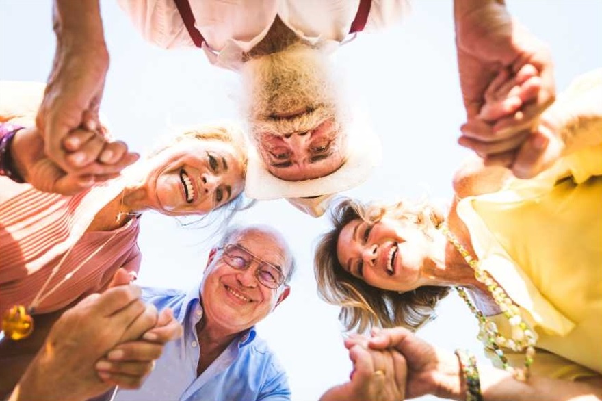 People standing in circle looking down