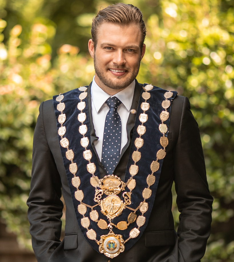 Cropped headshot of Mayor Zac Miles wearing Mayoral chains