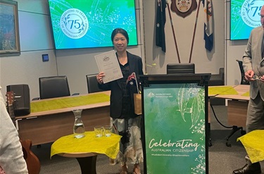 Conferee with her certificate at the citizenship ceremony